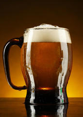 mug of beer on a yellow background