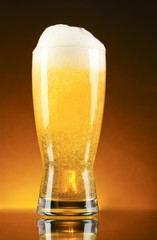 Glass of beer on dark background