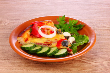tasty of pizza on a plate on a wooden background