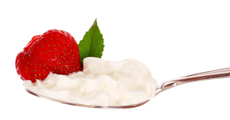 strawberry in spoon with cream isolated on white