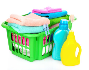 Detergents and towels in basket isolated on white