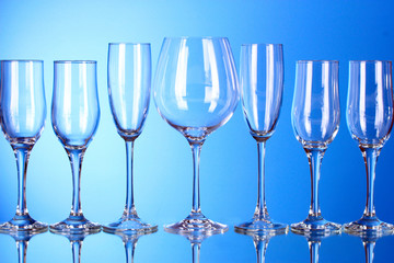 Few empty wine glasses on blue background
