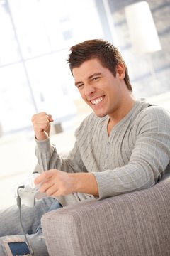 Young man happy about computer game