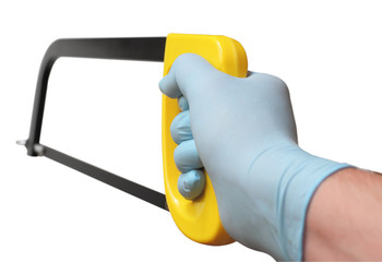 Men's gloved hand holding a hacksaw