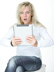 Surprised woman surfing on the internet with touchpad