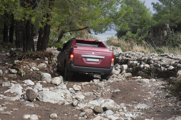 Fototapeta na wymiar Off-Road Vehicle on narrow dirt Road