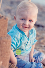 baby boy playing on beach