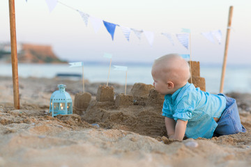 baby boy playing on beach