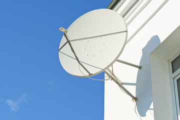 satellite antenna on a house facade - obrazy, fototapety, plakaty