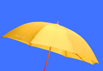 yellow beach umbrella against blue sky