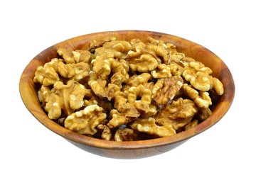 Walnuts in a wooden bowl on white background