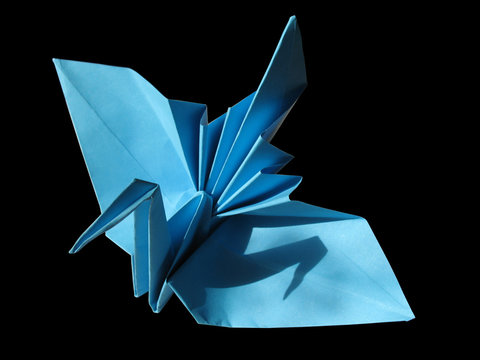 Origami festive crane isolated on black
