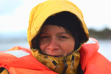 Young woman in rainy weather on a boat