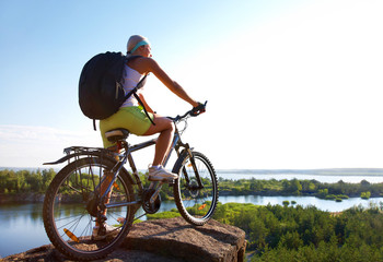 Girl with  bicycle on  mountain