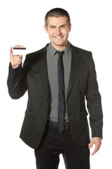 Young smiling businessman holding credit card