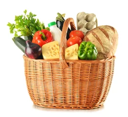 Fotobehang Groceries in wicker basket isolated on white © monticellllo