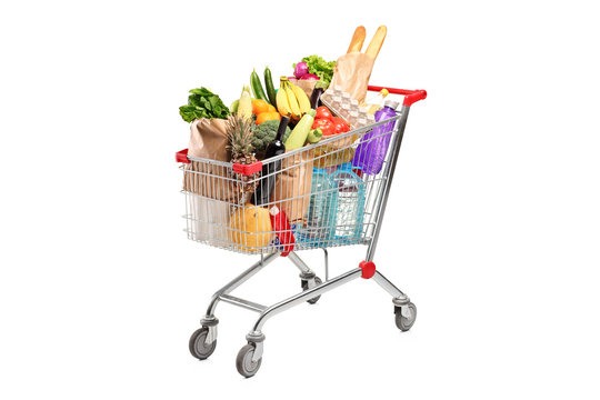 A shopping cart full with various groceries