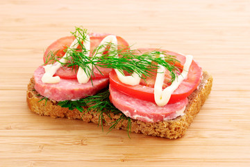 tomatoes and sausage on bread isolated on white