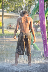 A kid playing in a water splash park
