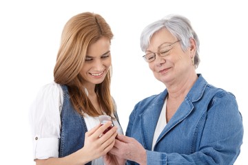 Mother and daughter looking at photos on mobile
