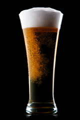 Beer into glass on a black