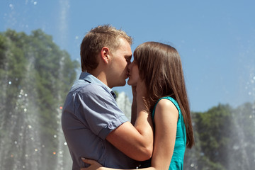 Love young couple kissing in the street