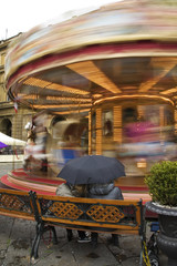 Women look at the carousel in Florence, Italy.