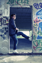 Asian boy in doorway of ruin