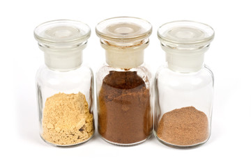 colorful spices in glasses with white background