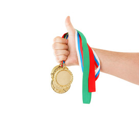 Gold medals in hand isolated on white