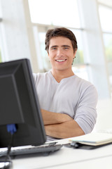 Relaxed man working in office