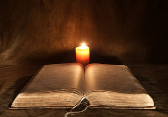 Opened Bible and Candle