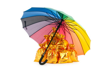 Golden sacks under protection of umbrella