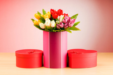 Giftbox and tulips against gradient background