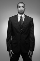 Young  African-American business man in black suit.