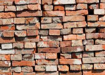A pile of old red bricks at construction site