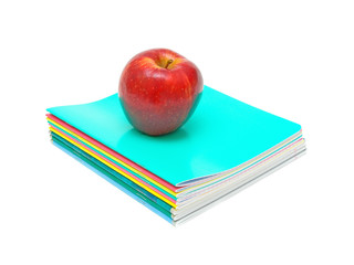 red apple lying on notebooks