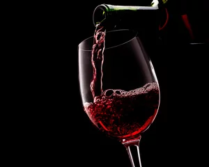 Fotobehang Red wine on a black background © Igor Klimov