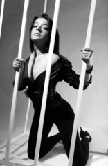 caucasian woman standing on knees near lattice rod