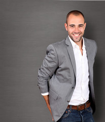 Cool businessman standing on grey background