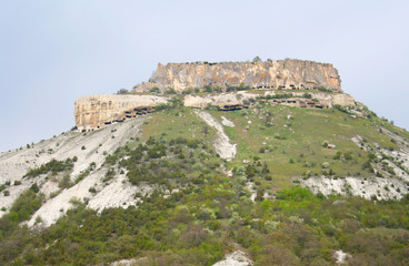 A rock with multiple caves inside