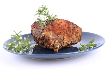 Roast pork decorated with rosemary blooming twigs