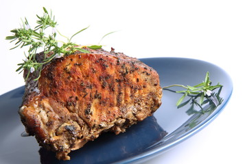 Roast pork decorated with savory blooming twigs