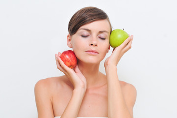 Beautiful woman with closed eyes with green and red apples