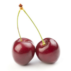 Red ripe cherries over white background
