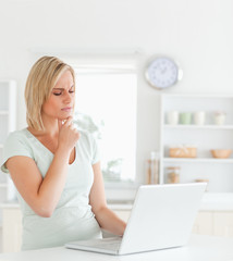 Fototapeta premium Wondering gorgeous woman looking at notebook