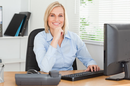 Working Cute Woman In Front Of A Screen Looking Into Camera