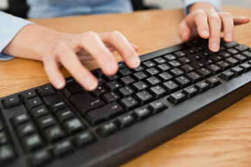 Woman typing on keyboard