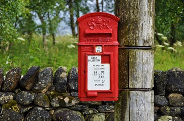 Traditional english postbox in countryside