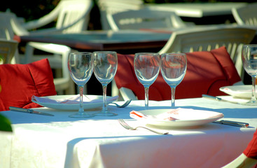 served table at restaurant on a terrace, on quay of mediterranea
